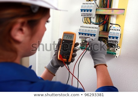 Stok fotoğraf: Female Electrician With A Voltmeter