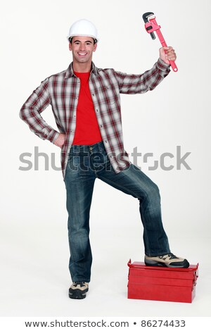Foto stock: Man Stood With One Foot On Tool Box