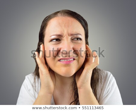 Сток-фото: Depressed Young Woman With Hands Over Her Head On Gray Background