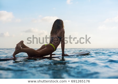 ストックフォト: Surfer Girl Surfing Looking At Ocean Beach Sunset