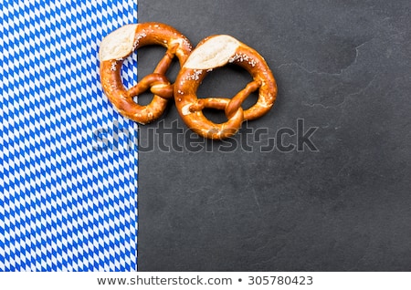 [[stock_photo]]: Pretzel On A Slate Plate With A Bavarian Decor