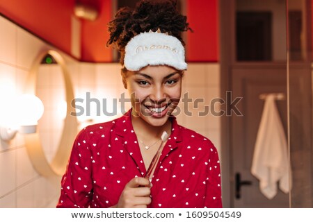 Foto stock: Girl Looking Into Bathroom Mirror