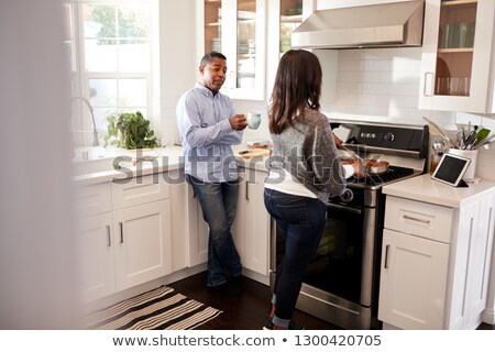 Stock fotó: Couple Holding Cups Standing In Doorway