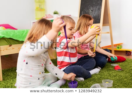 [[stock_photo]]: Kids With Modelling Clay Or Slimes At Home