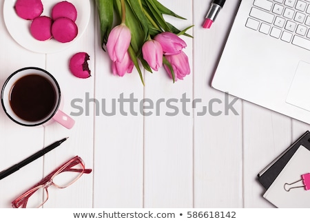 Foto stock: Glasses Tulips And Accessories In Pink Color On White Wooden Table