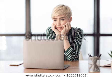 Сток-фото: Middle Aged Female Employee Sitting At The Office