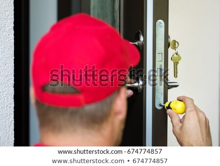 Сток-фото: Door Lock Service - Locksmith Working In Red Uniform