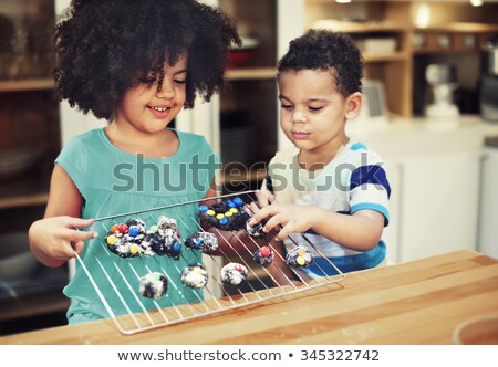 Stock photo: Cheerful Siblings Making A Dessert