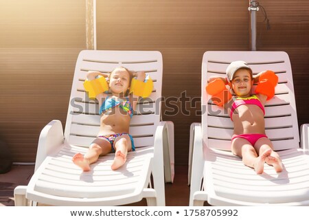 Foto stock: Young Couple Relaxing On Armchair On The Beach