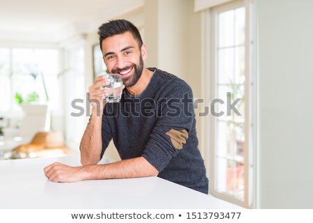 Stock fotó: Man Casually Drinking Glass Of Water