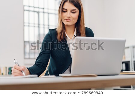 Foto stock: Businesswoman Working At Her Laptop In Her Office