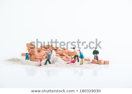 Miniature Worker And A Stack Of Sand Foto stock © Calvste