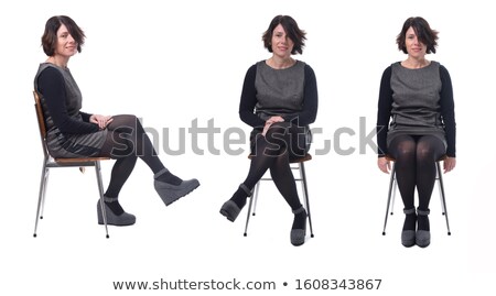 Stok fotoğraf: Front View Of Attractive Woman Sitting On Chair And Posing