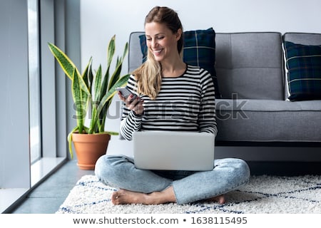 Stockfoto: Beautiful Young Female Using Her Laptop At Home