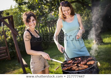 Two Pretty Girls Making Food On Grill Zdjęcia stock © BrunoWeltmann