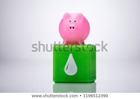 ストックフォト: Pink Piggybank Over Cubic Block With Waterdrop Icon