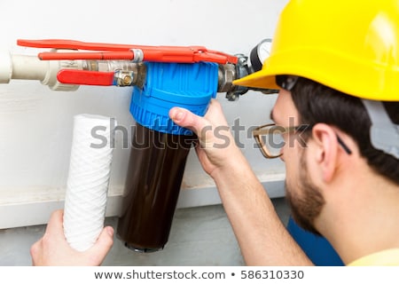 Stock photo: Water Filtration - Plumber Changing Dirty Water Filter
