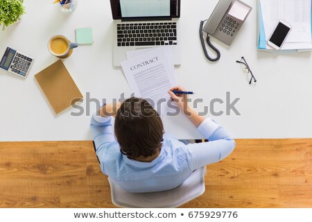 Stockfoto: Anonymous Woman Signing Documents At Table