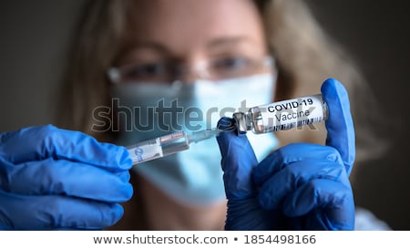 Stock photo: Coronavirus Vaccine Covid 19 Bottle For Injection In Hand Of Doc