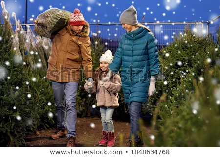 Stok fotoğraf: Woman And Man Buying Christmas Tree On Market