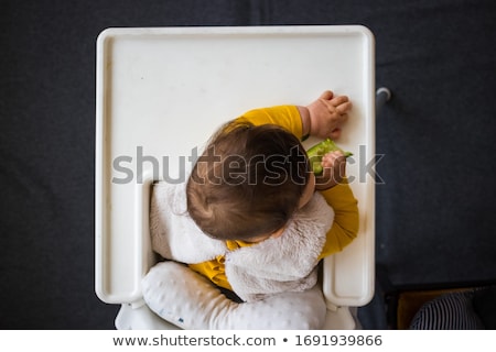 Foto stock: Little Asian Baby Girl On High Chair