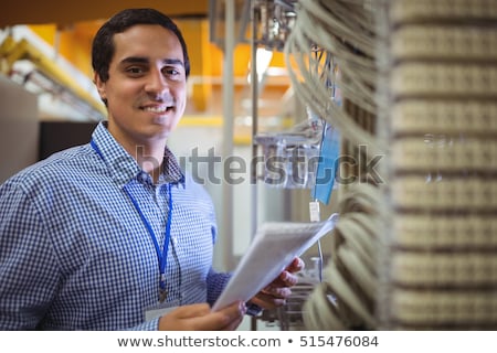 Foto stock: Portrait Of Technicians Analyzing Server