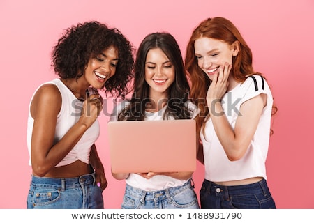 Foto stock: Woman Posing Isolated Over Pink Wall Background Using Laptop Computer