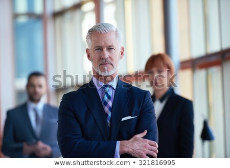 Older Businessman With A Woman In The Background [[stock_photo]] © dotshock