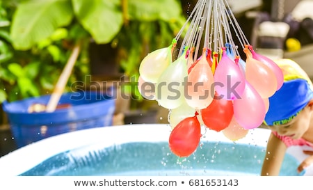 Foto stock: Happy Children Play Balloon Fight At The Beach