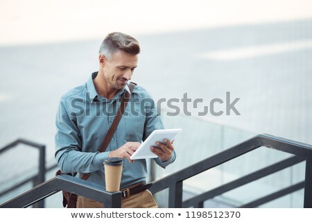 ストックフォト: Businessman With Tablet Pc And Coffee On Stairs
