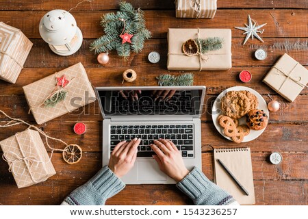 Foto d'archivio: Hands Of Female Over Keypad Surfing In The Net For Online Shops To Order Gifts