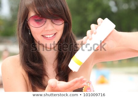 Сток-фото: Young Woman Protecting Herself From The Suns Harmful Rays