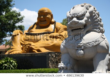 ストックフォト: Fat Laughing Buddha Over Blue Sky