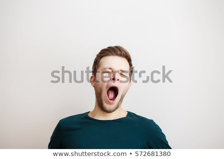 [[stock_photo]]: Portrait Of Young Man Yawning Isolated