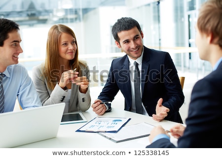 Foto stock: Business Partners Discussing Documents And Ideas
