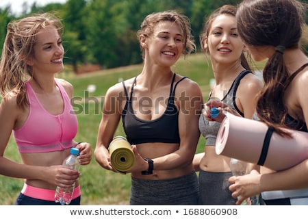 Zdjęcia stock: Young Cheerful Fit Woman Holding A Bottle With Water And Yoga Mat