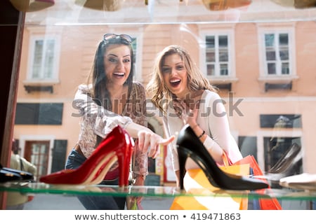 Stockfoto: Smiling Woman Looking At Shoes