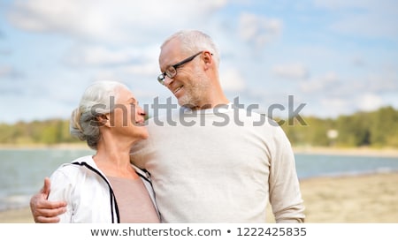 Stockfoto: Happy Senior Couple Hugging Over Beach Background