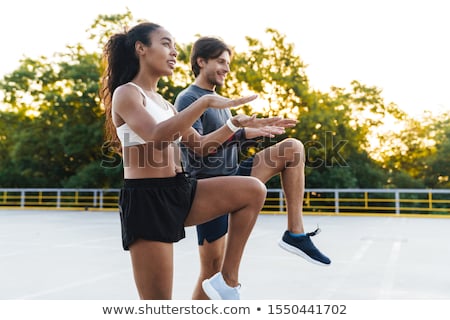 Stok fotoğraf: Photo Of Young Pleased Couple Doing Exercises While Working Out