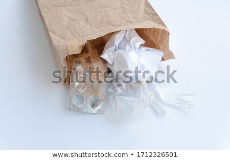 [[stock_photo]]: Man At Recycling Centre Disposing Of Old Newspapers