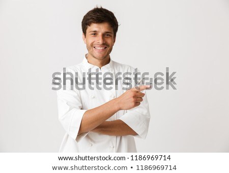 Stok fotoğraf: Chef Man Standing Isolated Over White Wall Background Pointing To Copyspace