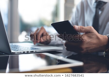 Foto stock: Mobile Phones And Digital Tablets On Table