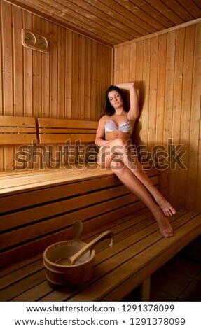 Foto stock: Pretty Woman Wearing Bikini And Sitting In Sauna