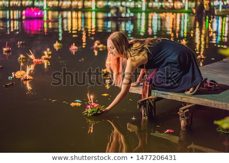 Сток-фото: A Female Tourist Holds The Loy Krathong In Her Hands And Is About To Launch It Into The Water Loy K