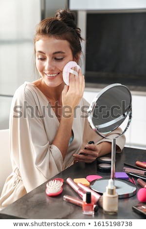 Stok fotoğraf: Woman Applying Makeup With Sponge