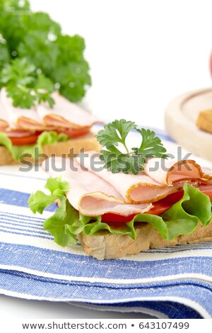 Сток-фото: Cropped View Of Breakfast Sandwiches With Parsley On Kitchen Towel