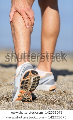 Foto stock: Runner Holding His Injured Leg