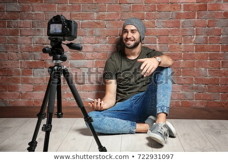 Stockfoto: Male Video Blogger With Camera Blogging At Home