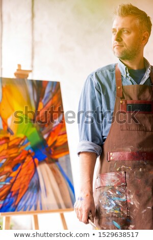 Stock photo: Mature Professional Painter In Apron Standing Inside Studio Of Arts