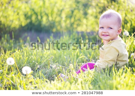Сток-фото: A Cute Little Baby Boy Sit In The Grass